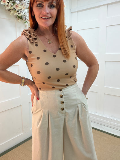 Tiara: Cream cropped wide leg buttoned front trousers. 4 sizes
