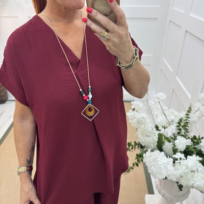 Eliza: Burgundy V neck top & pendant. One size: 14-20