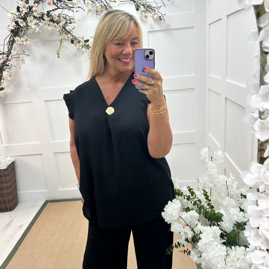 Drew: Black V neck button top. One size: 14-20