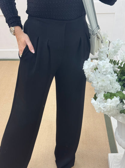 Tayla: Black high waisted pleated wide leg trousers. One size: 10-16