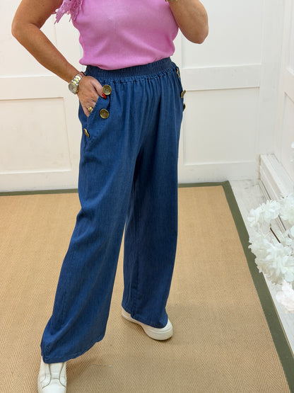 Denver: Mid denim gold button wide leg trousers. 12-18