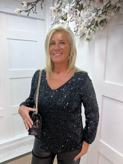 Sutton: Black v-neck sequin top. One size: 12-16