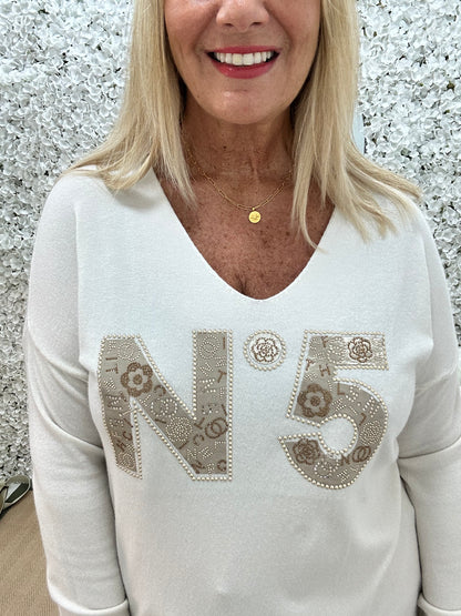Cass: Cream V neck diamanté No5 knit top. One size: 14-20