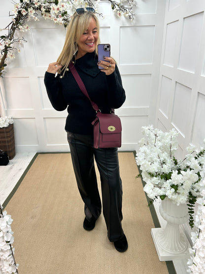 Rumer: Black split neck button top. One size 12-18