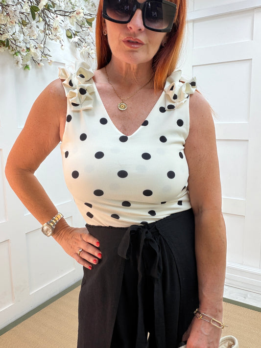 Rhian: Polka dot ruffle shoulder V neck vest top. One size: 10-16
