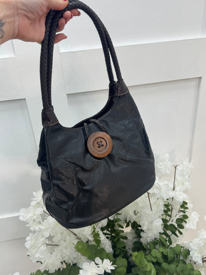 Pipa: Black slouchy big button shoulder bag.
