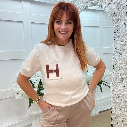 Harley: Cream H logo knit top. One size: 10-16