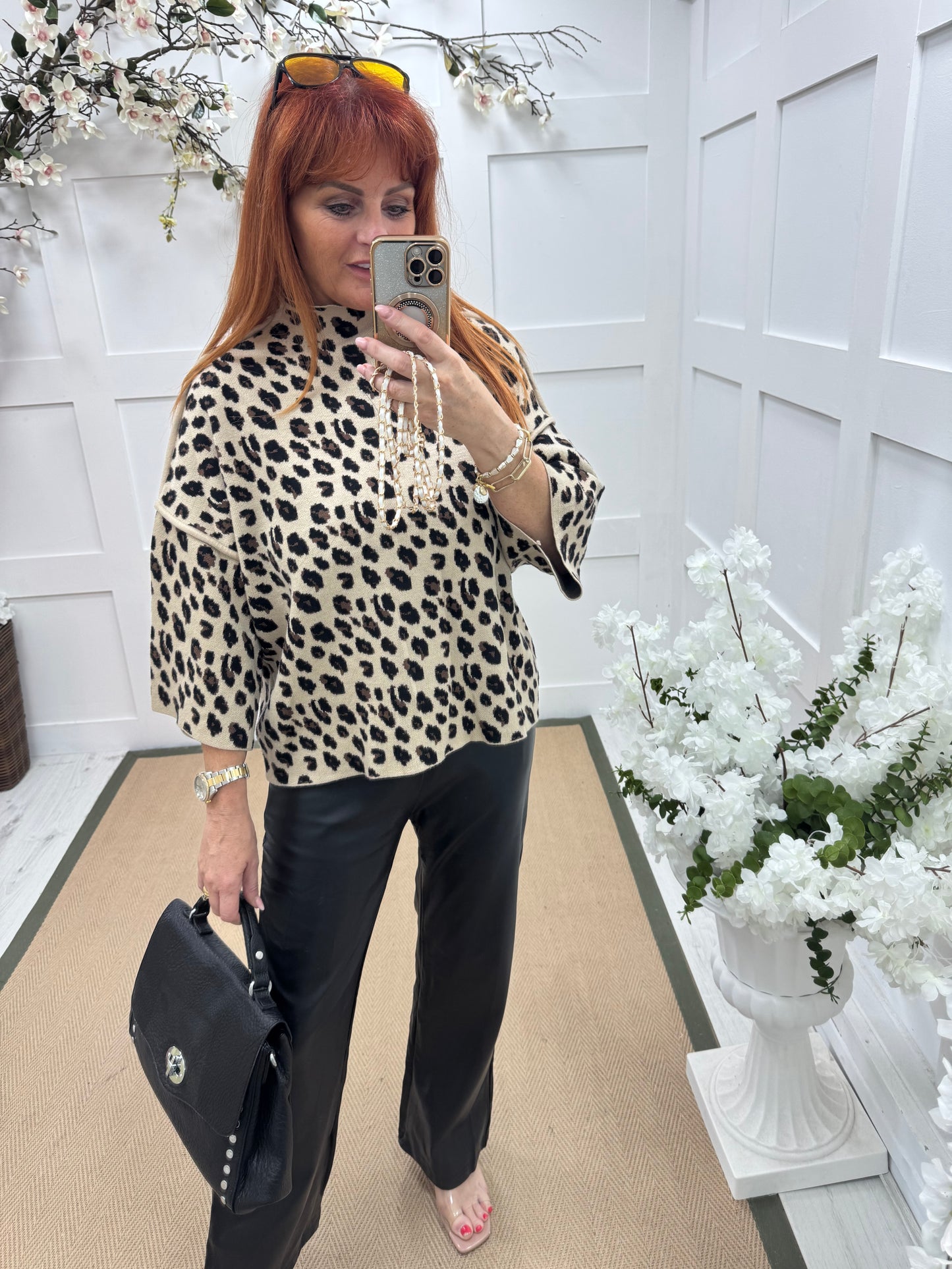 Geri: Black faux leather wide leg trousers.