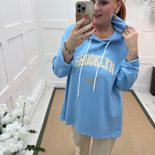 Madison: Baby blue Brooklyn logo hoodie. One size: 12-18