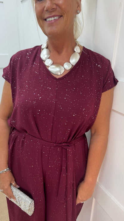 Gia: Burgundy sparkle tie-waist wide leg jumpsuit. One size: 12-18