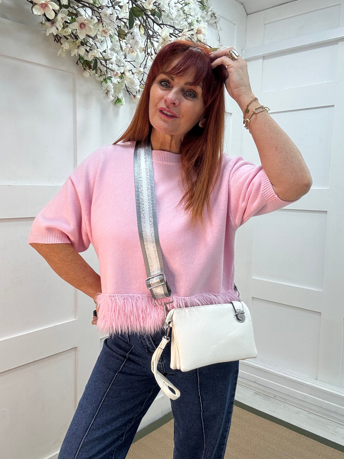 Britt: White three pocket crossbody bag.