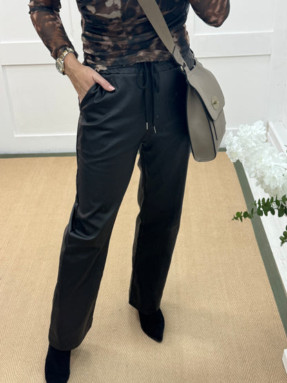 Quinn: Black faux leather trousers. One size: 10-14