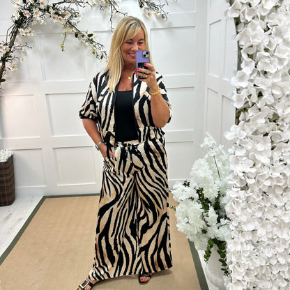 Aven: Black zebra print wide leg trousers. One size: 10-16