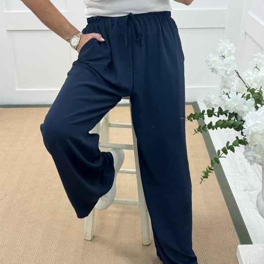 Esme: Navy pocket wide leg trousers. One size: 12-20