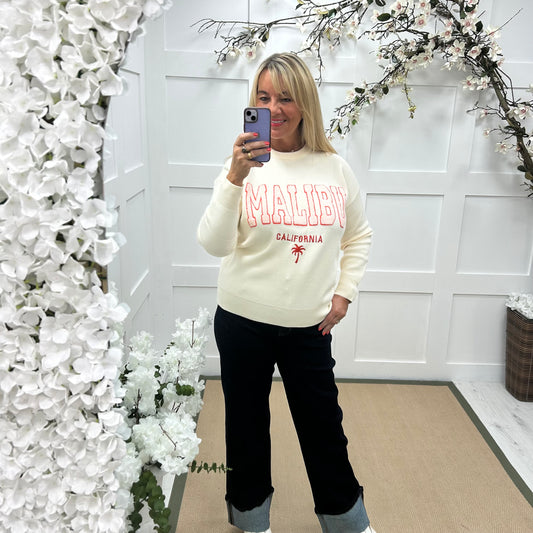 Melody: Cream textured MALIBU logo knitted top. One size 10-18