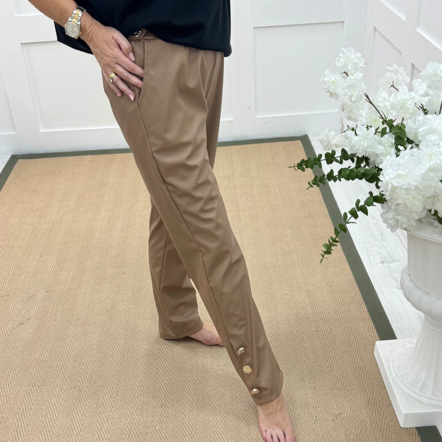 Tatum: Coffee faux leather button trousers. One size: 14-18