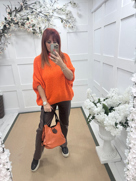 Pipa: Orange slouchy big button shoulder bag.