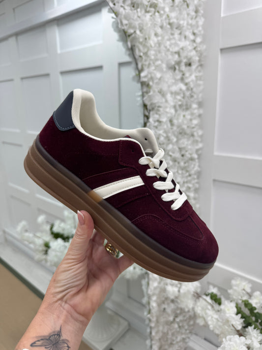 Noa: Burgundy trainers with white stripe. Sizes: 3-8