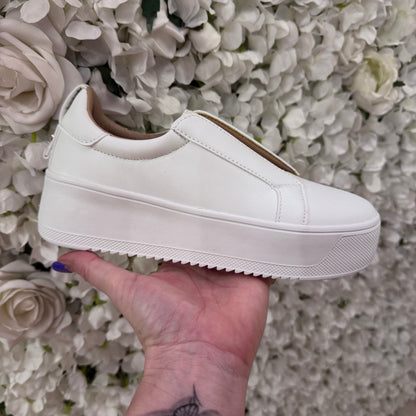 Riva: White slip on platform trainer. Sizes: 3-8