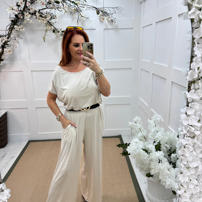 Rhianna: Cream jersey draped wide leg jumpsuit. One size: 10-16