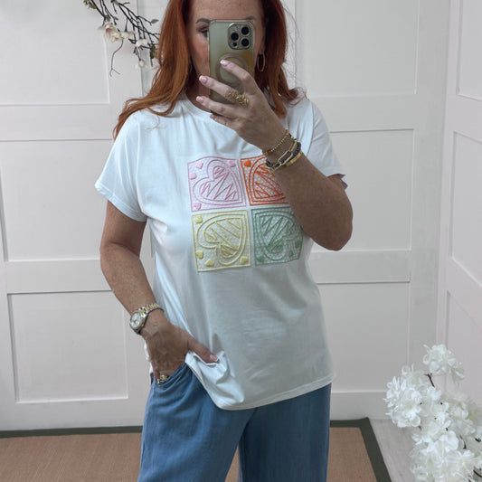Sophie: White embroidered orange heart T shirt. One size 14-18