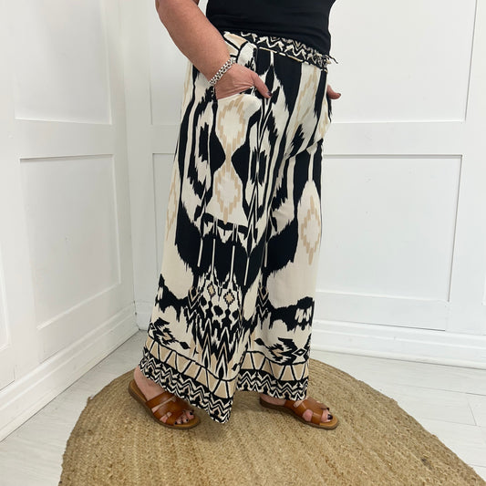 Brooke: Black aztec print wide leg trousers. One size: 12-18