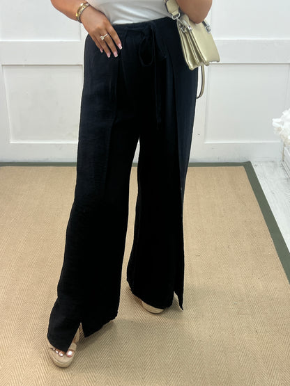 Eden: Black tie waist wide leg trousers. One size: 10-16