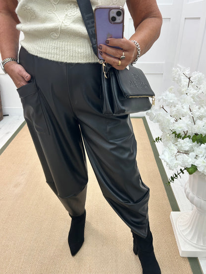 Drew: Black faux leather cocoon trousers. One size: 12-18