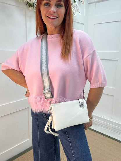 Britt: White three pocket crossbody bag.