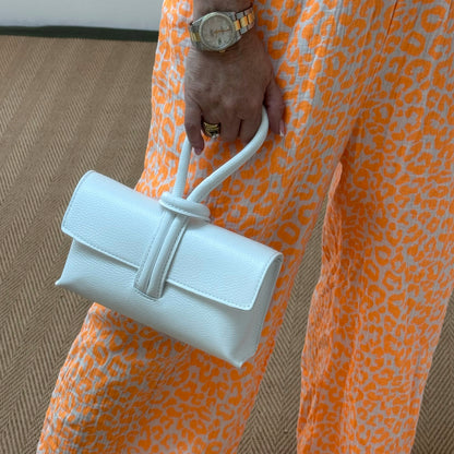 Alexis: White leather loop handle cross body/clutch bag.