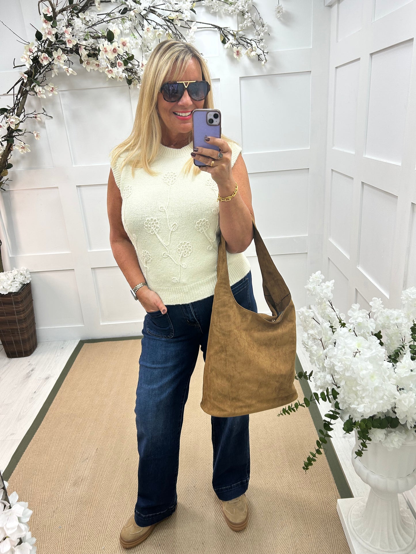 Larry: Cream sleeveless tank top with flower detail. One Sz: 12-18