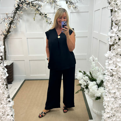 Drew: Black V neck button top. One size: 14-20