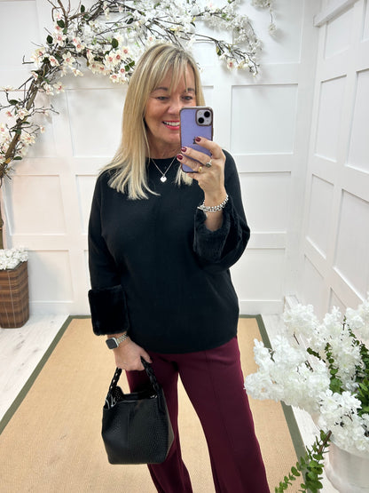 Coco: Black faux fur cuff knitted top. One size: 14-18