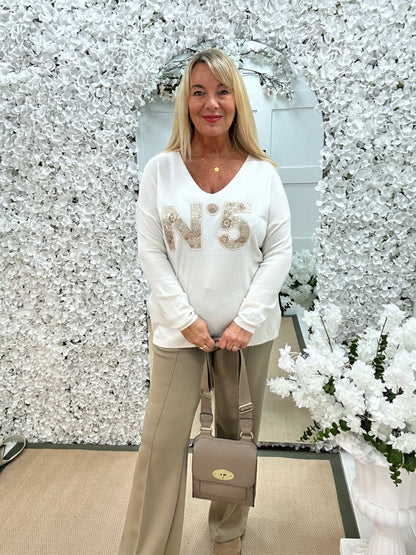 Cass: Cream V neck diamanté No5 knit top. One size: 14-20