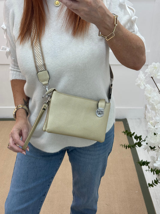 Britt: Gold three pocket crossbody bag.